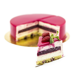 pink raspberry cake with raspberry jam on a white plate with mint