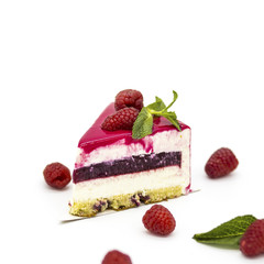 pink raspberry cake with raspberry jam on a white plate with mint