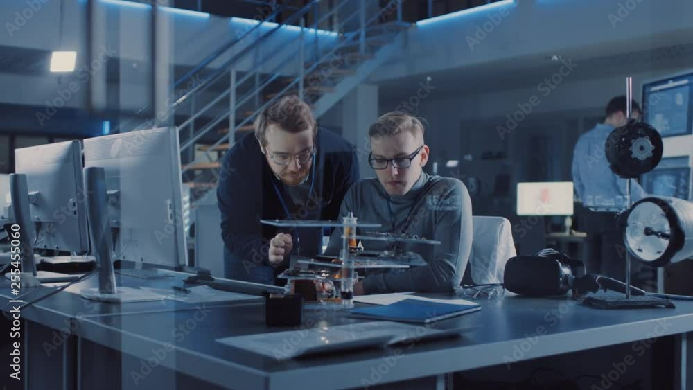 Poster Electronics Development Engineer Talks with Project Manager, they Choose PCB Motherboard to Hold Device Microchip. Team of Professionals Use Digiral Whiteboard, Tablets and CAD Software