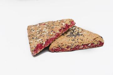 Bunch of integral fruit biscuits with cherries isolated on white background. Healthy food, copy space. Integral biscuit isolated on white backgorund