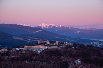 Aerial view of Burnaby Mountain during a vibrant sunset. Taken in Greater Vancouver, British Columbia, Canada.