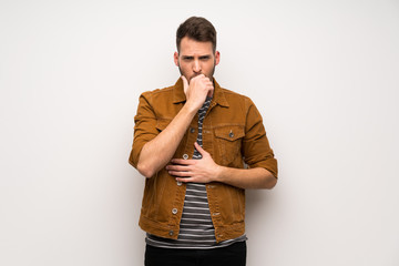 Handsome man over white wall is suffering with cough and feeling bad