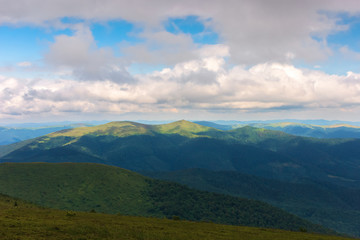 Obraz premium mountain landscape with cloudy sky. peaks of distant ridge in sunlight. beautiful scenery after the storm