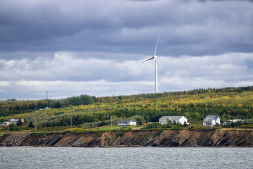 Residential homes on a rocky coast during a cloudy day. Taken in Victoria Mines, Nova Scotia,...