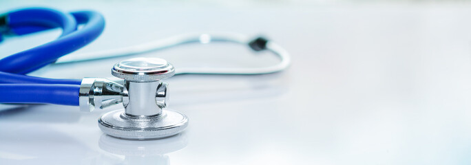 Stethoscope or phonendoscope on a doctor's white desk. Treatment of cold or flu, banner size
