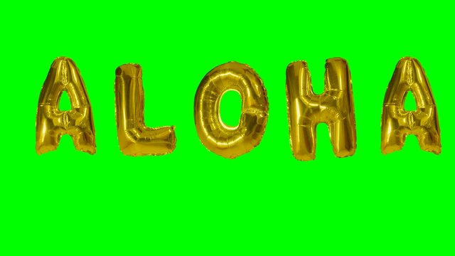 Word aloha from helium gold balloon letters floating on green screen