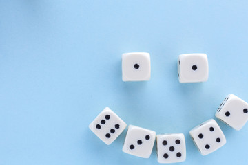 White gaming dices on light blue background. victory chance, lucky. Flat lay, place for text. Top view. Close-up. Concept gamble. spectacular pastel