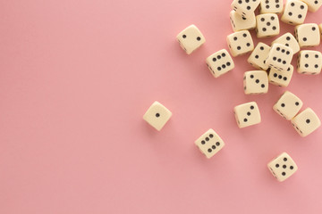 White gaming dices on pink background. victory chance, lucky. Flat lay, place for text. Top view. Close-up. Concept gamble. spectacular pastel