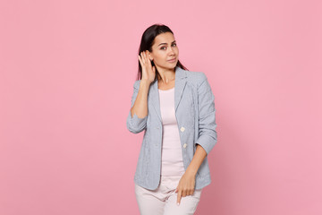 Portrait of attractive young woman in striped jacket eavesdrop with hearing gesture near ear...