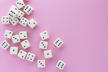 White gaming dices on violet background. victory chance, lucky. Flat lay, place for text. Top view. Close-up. Concept gamble. spectacular pastel