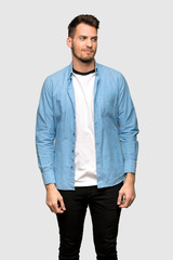 Fototapeta premium Handsome man looking to the side over grey background