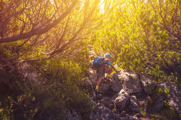 Overcoming obstacles conceptual photo kid climbing over big rocks