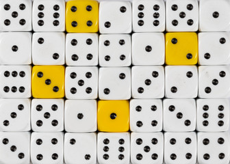 Background of random ordered white dices with four yellow cubes