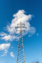 a high voltage power pylons against blue sky