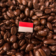 a monaco flag placed over roasted coffee beans