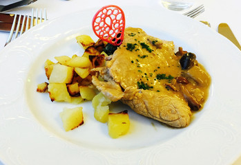 Escalope with mushroom on cream sauce and potatoes