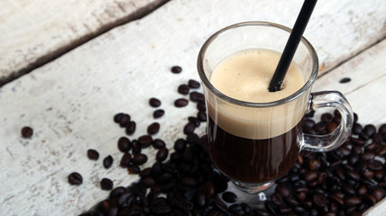 Irish coffee in glass on wooden table.