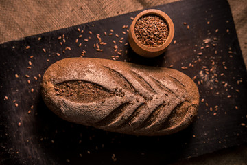 bread with cumin seeds flax dark board kitchen cooking table dark taste flavor