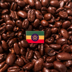 a Ethiopia flag placed over roasted coffee beans
