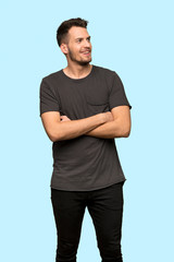 Man with black shirt Happy and smiling over blue background