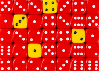 Background of random ordered red dices with four yellow cubes