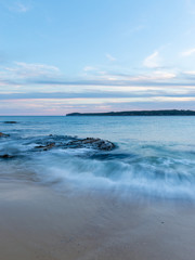 Fototapeta na wymiar Long exposure of water motion at the beach shore.
