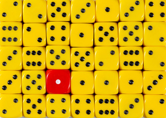 Background of random ordered yellow dices with one red cube