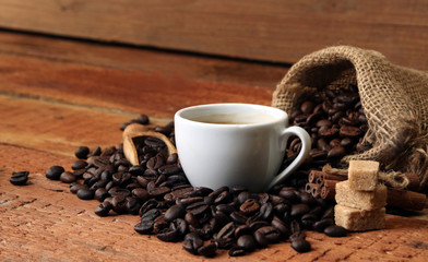 Coffee cup with Coffee beans, burlap sack and with cinnamon sticks