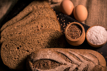 bread with cumin seeds flax dark board kitchen cooking table dark taste aroma salt flour bag
