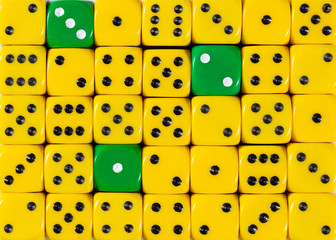 Background of random ordered yellow dices with three green cubes