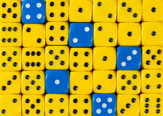 Background of random ordered yellow dices with five blue cubes
