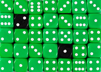 Background of random ordered green dices with two black cubes