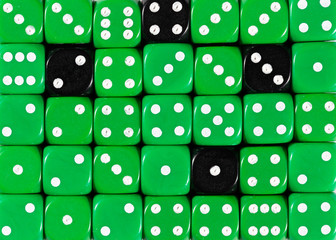 Background of random ordered green dices with four black cubes