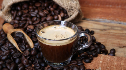 Coffee cup with Coffee beans, burlap sack and with cinnamon sticks