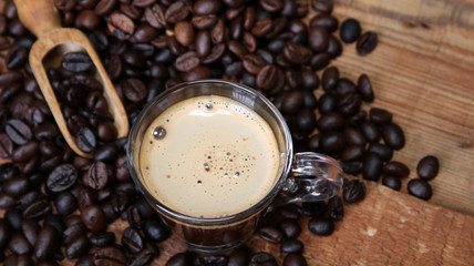 Coffee cup with Coffee beans, burlap sack and with cinnamon sticks