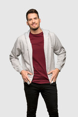 Fototapeta premium Man with sweatshirt laughing looking to the front over grey background