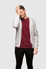 Man with sweatshirt has realized something and intending the solution over grey background
