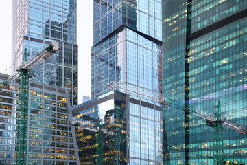 Fototapeta premium Complex of high-rise buildings under construction with construction cranes. Moscow. 15.12.2016