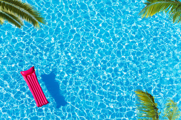Vacation pool with matrass surface and palm trees - obrazy, fototapety, plakaty