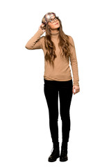 Full-length shot of Young woman with beret thinking an idea while scratching head on isolated white background