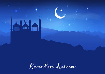 Ramadan Kareem background with mosque silhouettes against night sky