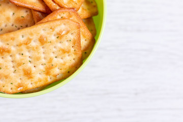 Crackers in green plastic bowl