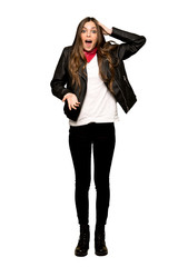 Full-length shot of Young woman with leather jacket with surprise and shocked facial expression on isolated white background