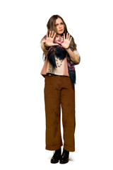 Full-length shot of Young hippie woman is a little bit nervous and scared stretching hands to the front on isolated white background