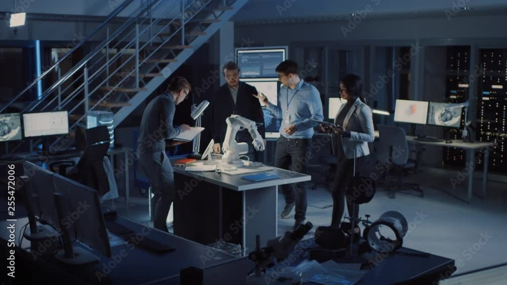 Leinwandbilder Team of Electronics Development Engineers Standing at the Desk Working on Robot Arm Prototype. Specialists Working on Ultra Modern Industrial Design, Using Machine Learning. Slow Motion