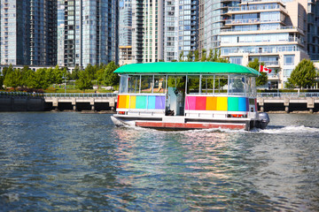 Fototapeta na wymiar Aquabus or Water Taxi on False Creek in Downtown Vancouver