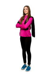 Fototapeta premium Full-length shot of Young sport woman with arms crossed and looking forward over isolated white background