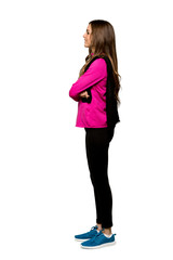 Full-length shot of Young sport woman in lateral position over isolated white background