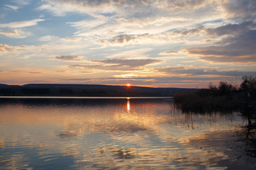 Landscape of pure spring sunset over lake.