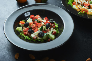 Greek salad of fresh cucumber, tomato, sweet pepper, lettuce, red onion, feta cheese and olives with olive oil. Healthy food, top view